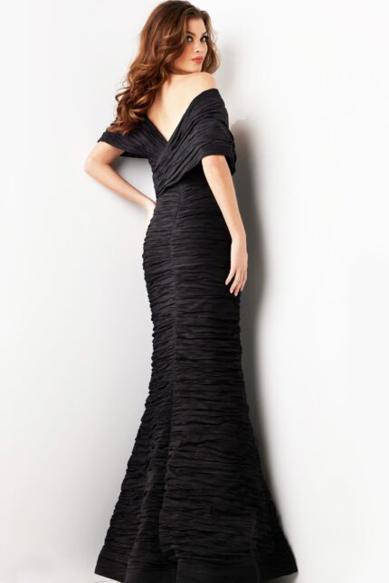 Model displaying the back of Jovani 38954 black gown with mermaid style.