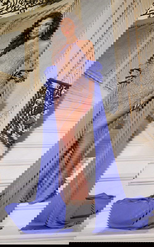 Model displaying 38956 nude gown with halter neckline and dramatic flair.