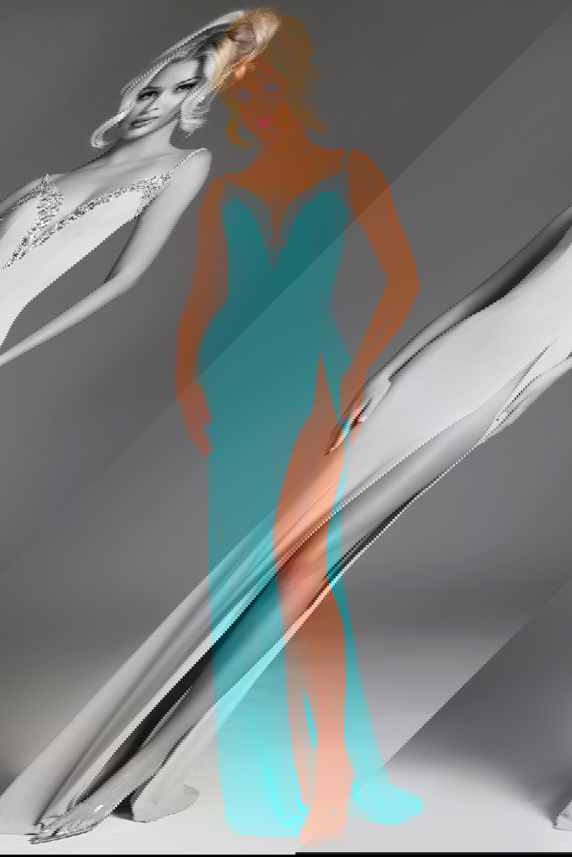 38989-blue-8 Model wearing Jovani 38989 elegant blue gown with deep V-neckline and high slit.