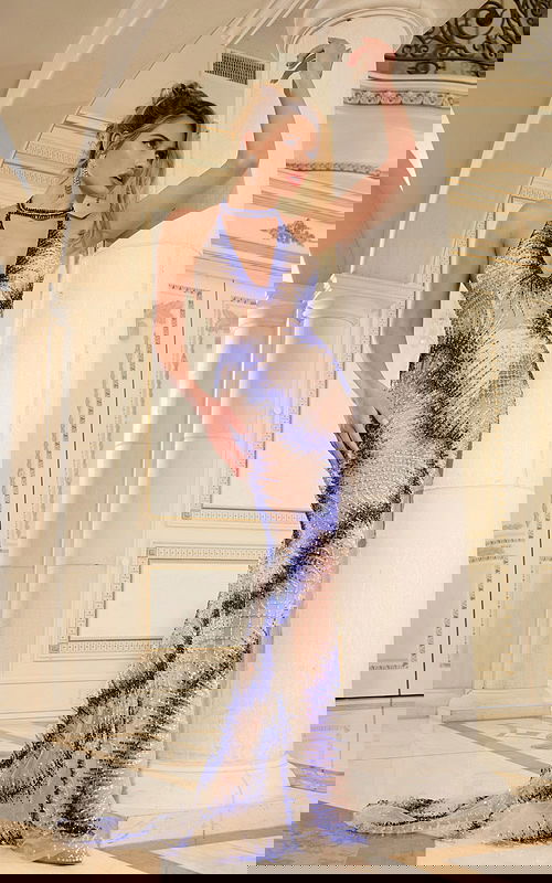 Model wearing Jovani 39037 royal blue gown with deep V-neckline and floor-length silhouette