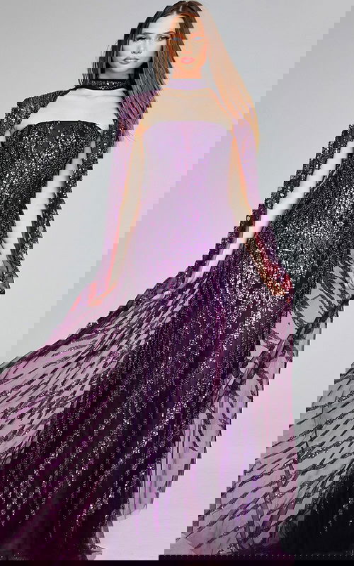 Model wearing Jovani 39046 purple gown with sequins and cape sleeves, front view.