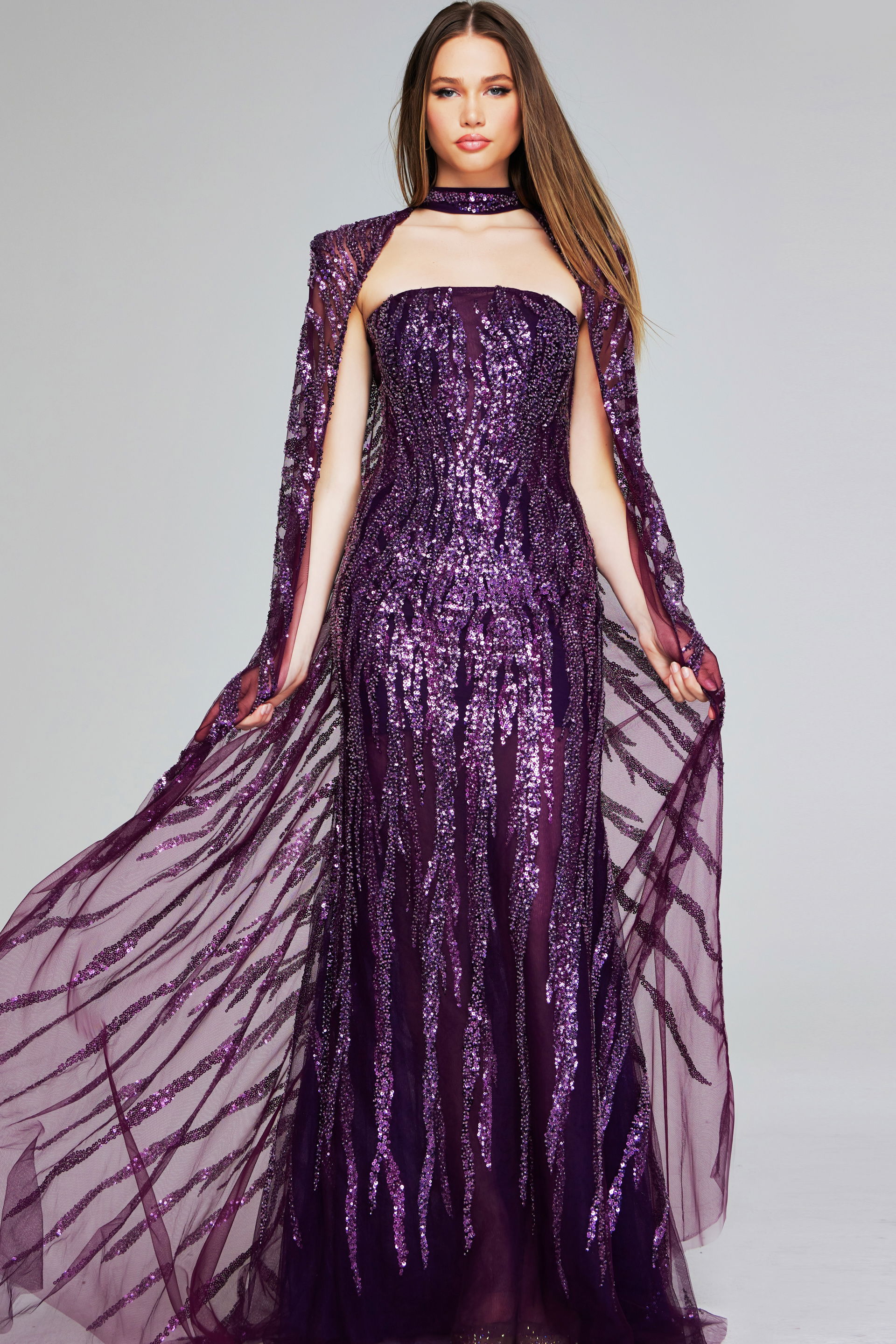 39046-PURPLE-204.jpg Model wearing Jovani 39046 purple gown with sequins and cape sleeves, front view.