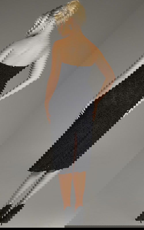 Model wearing Jovani 39076 black dress with floral embroidery, front view