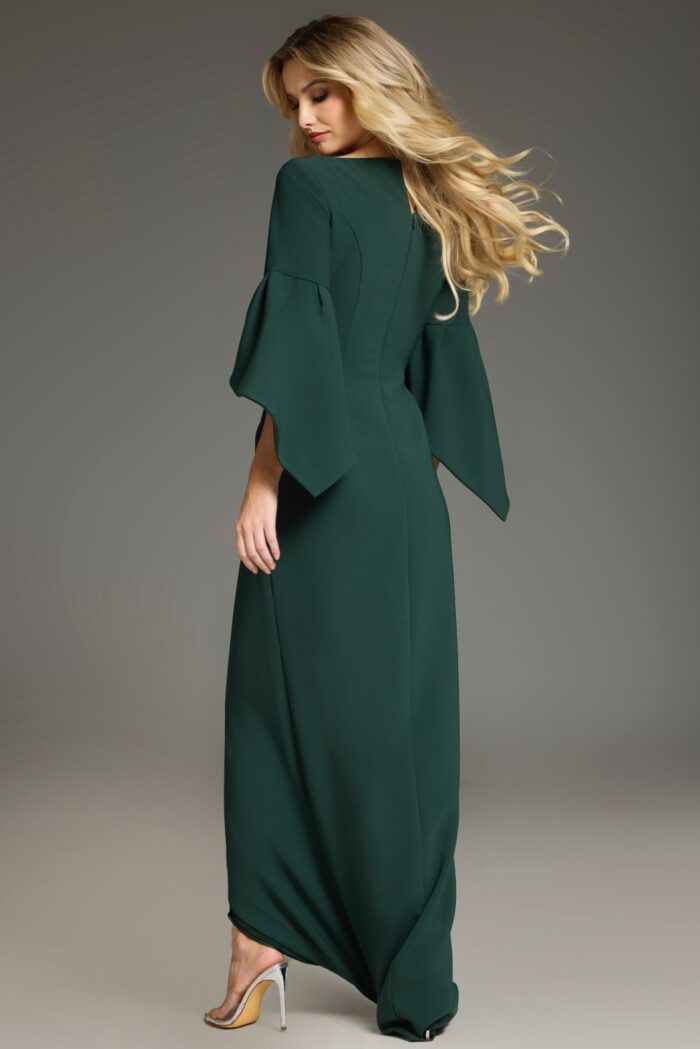 Model wearing Jovani 39082 green dress, showing back view with bell sleeves