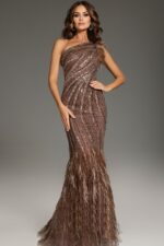 Model wearing Jovani 39170 brown gown with one-shoulder neckline, sequins, and feather detail, front view.