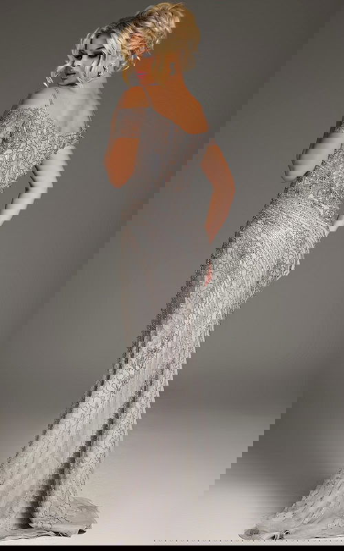 Model wearing Jovani 39175 silver dress, viewed from the back, highlighting the elegant silhouette and intricate details.