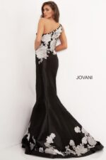 Model wearing Jovani 3918 black dress with silver floral lace, back view.