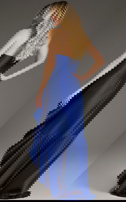 Back view of model in Jovani 39265 blue gown with cascading ruffles