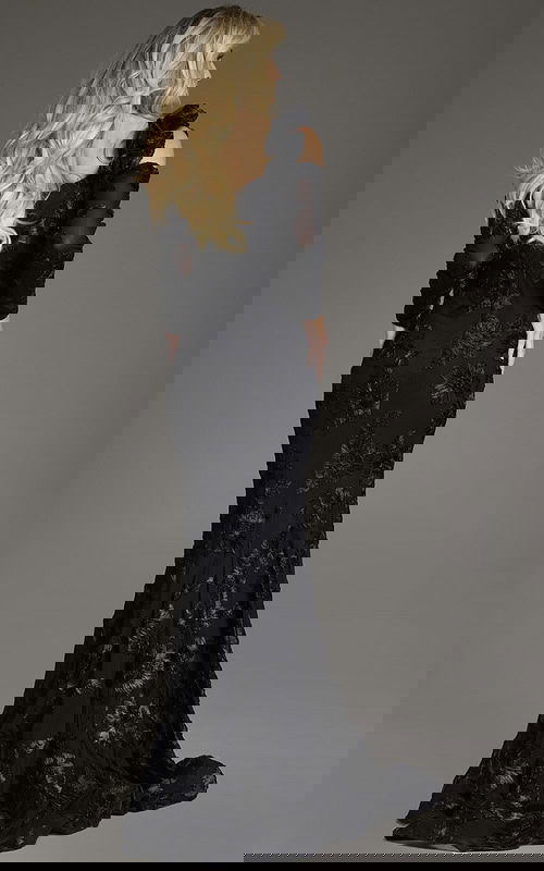 Model in Jovani 39266 showing the off-the-shoulder neckline and floral design.