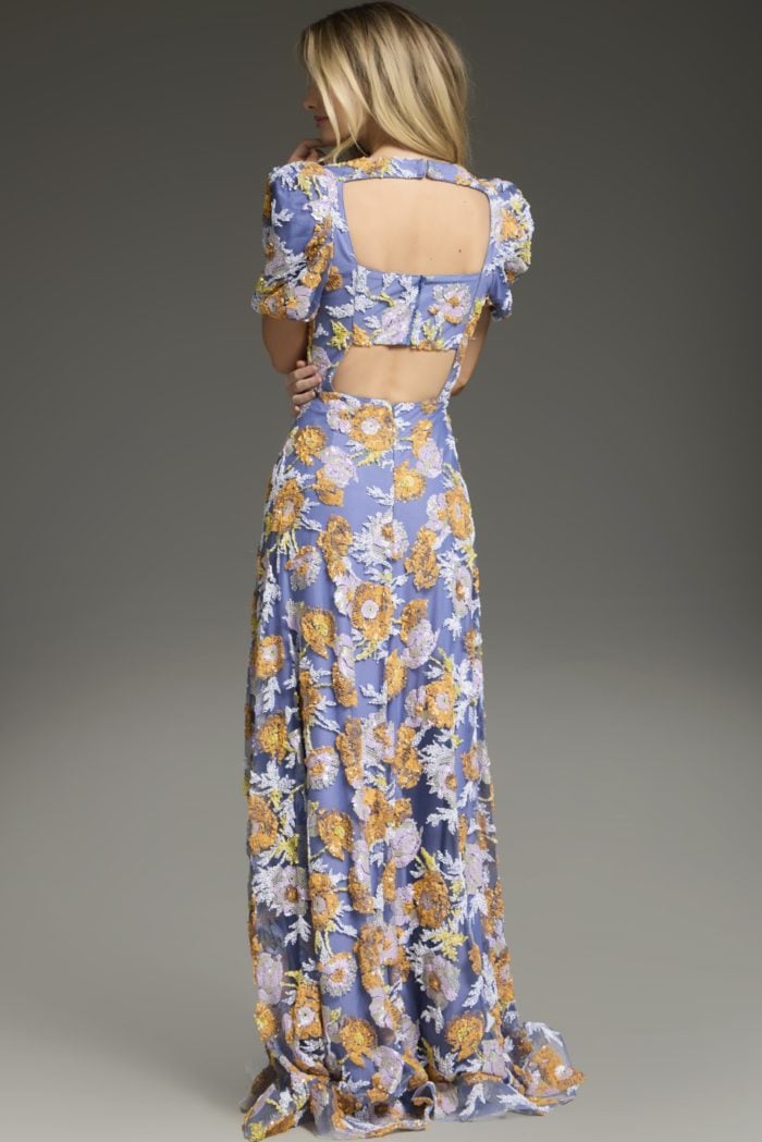 Model wearing Jovani 39273 multi-colored dress with open back and floral embroidery, back view.