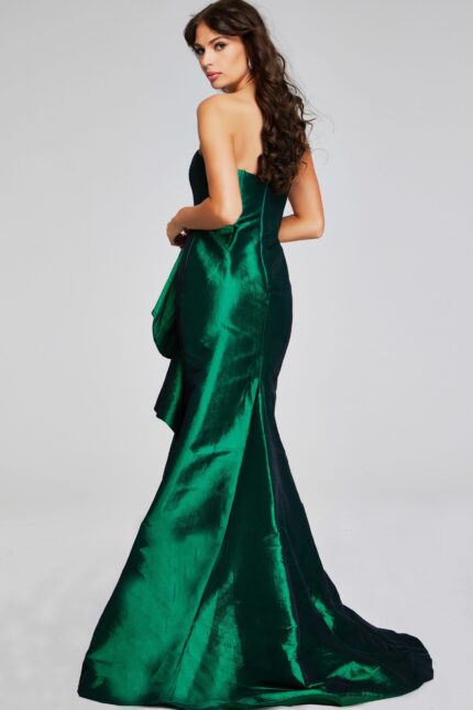 Model wearing Jovani 39368 green gown, back view showcasing mermaid silhouette.