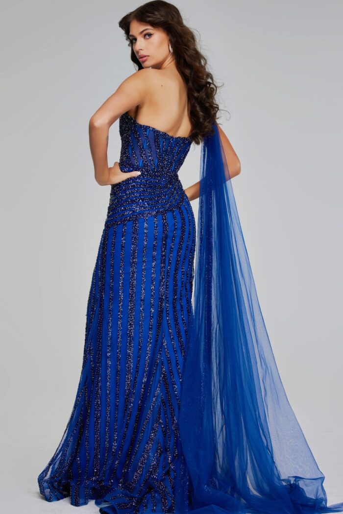 back view of model wearing Jovani 39386 navy gown with cascading fabric and beading