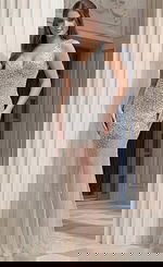 Jovani 39502 silver and nude crystal encrusted pageant gown with deep V-neckline, allover rhinestone embellishment graduating from dense coverage at the bodice to scattered crystals on the sheer tulle skirt.