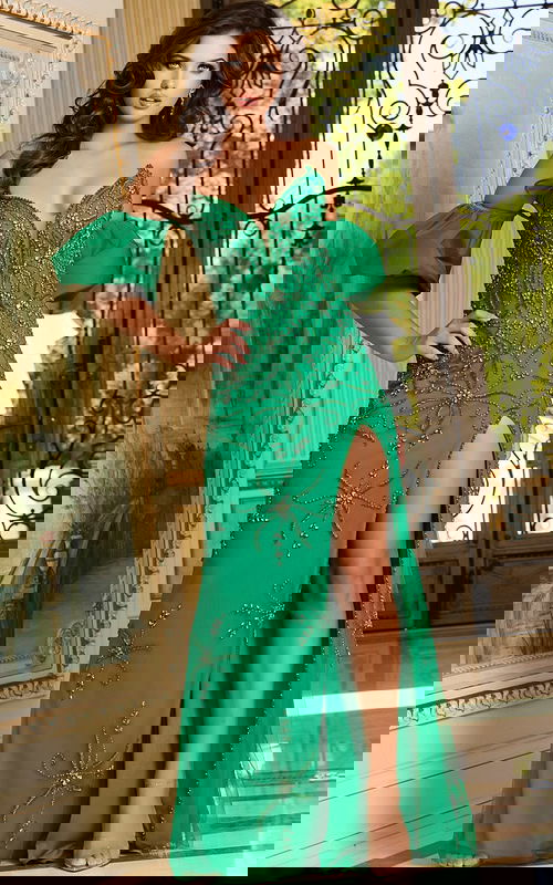 Model wearing Jovani 39615 green dress with sweetheart neckline and high slit