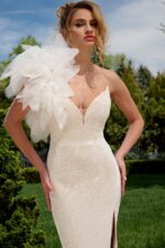 Close-up of model in Jovani 39617 white gown featuring sequin texture and one-shoulder detail.