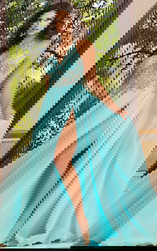 Model showcasing Jovani 39642, blue gown with a high slit and halter neckline.