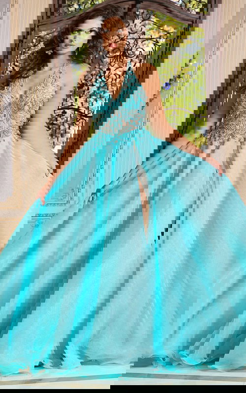 Model wearing Jovani 39642, an embellished blue halter neckline gown with a high slit.