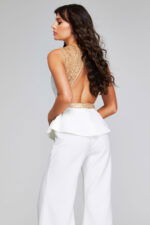 Model in Jovani 39720 ivory jumpsuit with elegant back detailing.