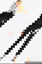 Model Wearing Black Off-the-Shoulder Pantsuit with Oversized Bow Details and Long Sleeves