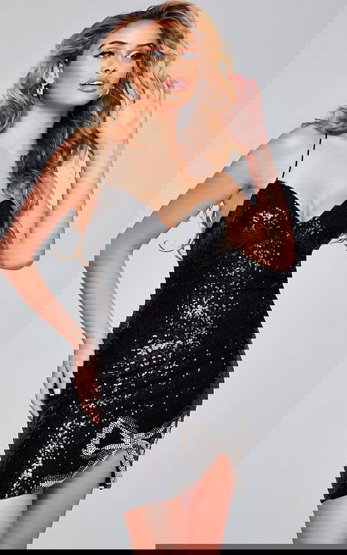 Model wearing Jovani 39844 black sequin mini dress with deep V neckline.