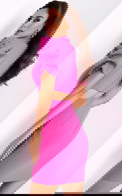 Side view of crop top and pencil skirt set in bold pink