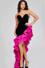 Model wearing Jovani 39885 black dress with fuchsia ruffle detail, front view.