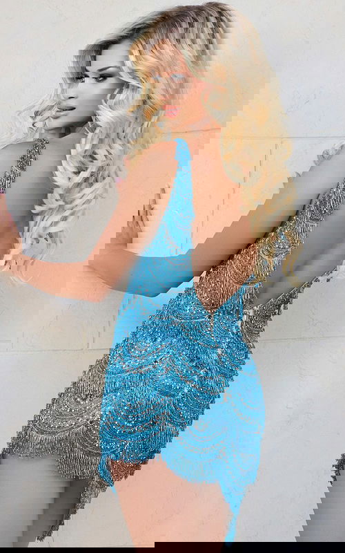 Model wearing Jovani 39909 blue mini dress with low back and fringe details, back view.