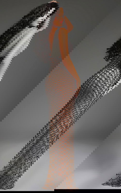 Model showcasing the back view of Jovani 39917 black gown with elegant beadwork.