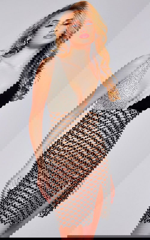 Model wearing Jovani 39918 with a deep V-neckline and beaded detailing.