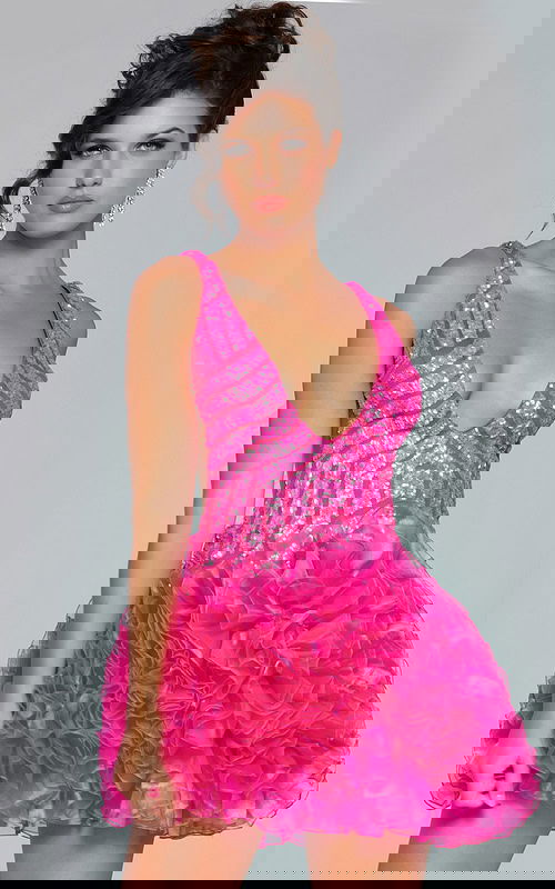 Model wearing Jovani 39931 dress in pink with deep V-neckline and ruffled skirt.