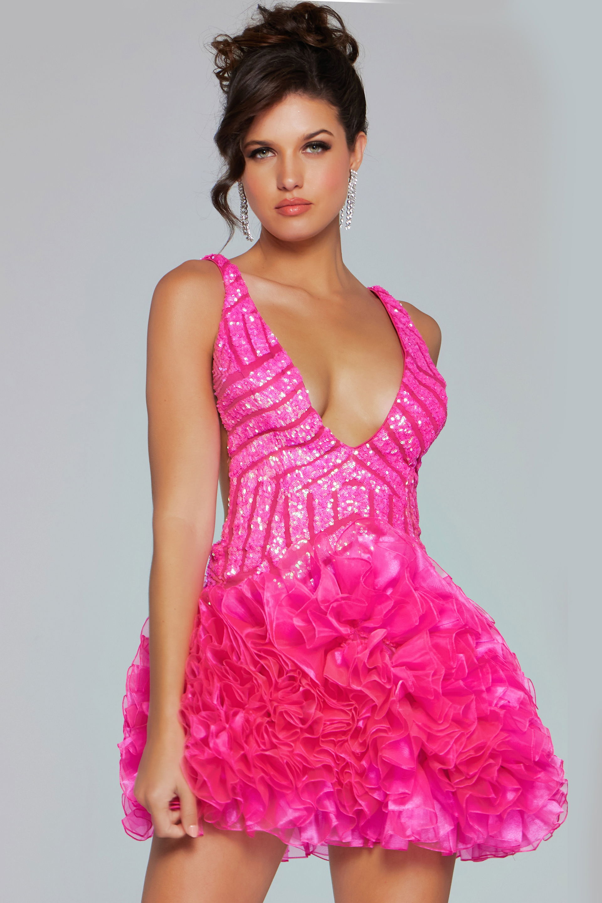 39931-205.jpg Model wearing Jovani 39931 dress in pink with deep V-neckline and ruffled skirt.