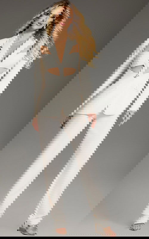 model wearing Jovani 39969 ivory suit showcasing the back cutout detail