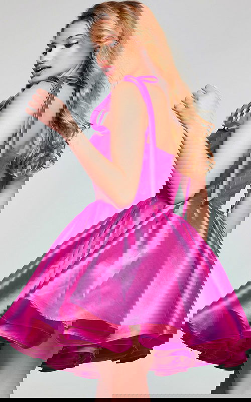 Side view of model wearing Jovani 39979 pink dress showing tied shoulder details.