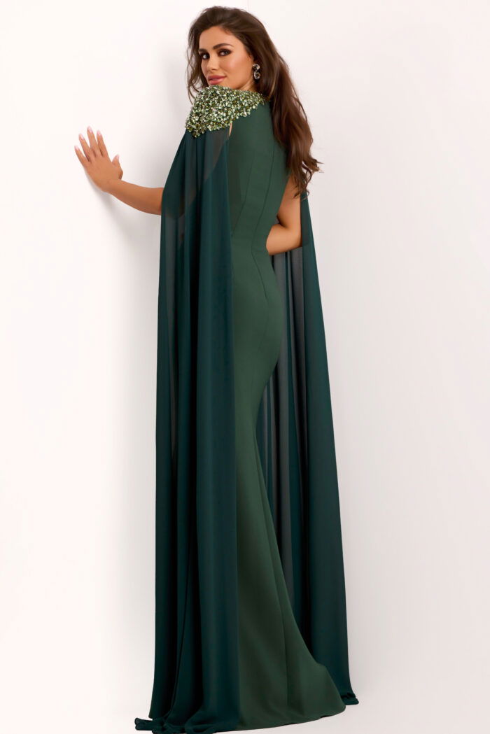 Back view of green formal cape gown with jeweled shoulders