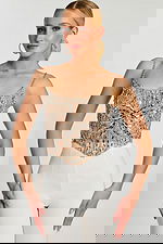 sequin pattern and structured silhouette of silver crop top.