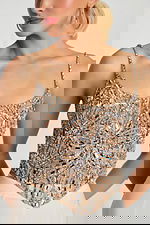 Close-up of intricate silver beadwork on nude mesh top with scoop neckline.