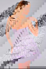 Back view of model in Jovani 40030 lilac dress with strapless neckline and tiered skirt.