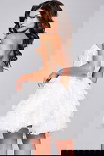 Back view of model in Jovani 40030 dress in white, highlighting the strapless design and layered skirt.