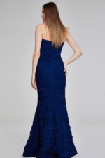 Model wearing Jovani 40045 navy mermaid gown, back view.