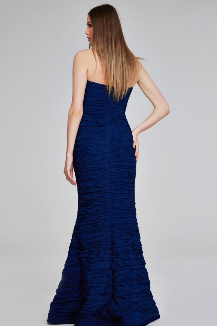 Model wearing Jovani 40045 navy mermaid gown, back view.