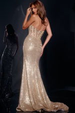 Model wearing Jovani 40058 gold gown, back view with fitted silhouette.