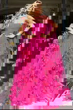 Vibrant pink evening gown adorned with cascading floral tulle details