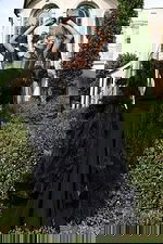 Luxurious statement dress with layered petals and transparent overlay