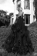 Floor-length pink gown with sheer tulle cape and floral accents