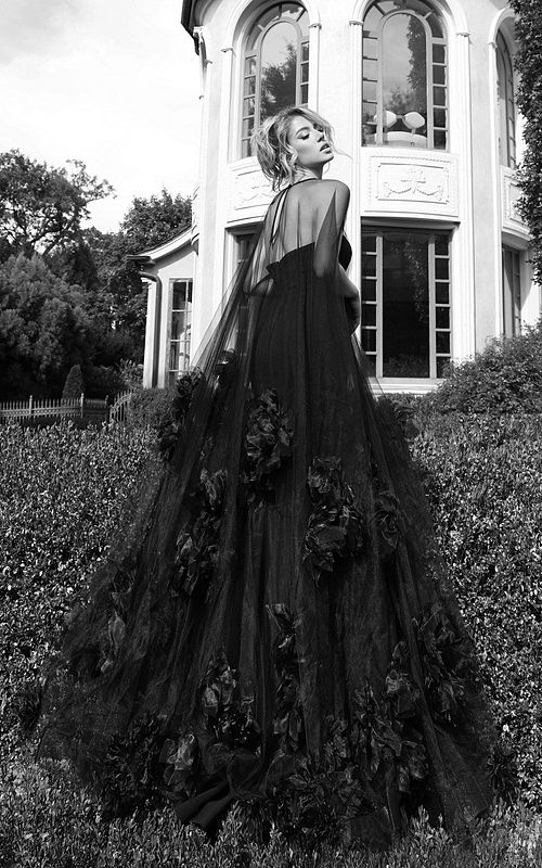 Floor-length pink gown with sheer tulle cape and floral accents