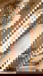 Back view of a fitted one shoulder formal dress with a clean silhouette and center slit