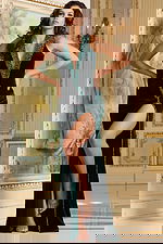 Model in Jovani 40119 green gown, showcasing front details and high slit.