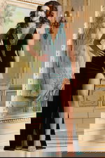 Model wearing Jovani 40119 green gown with V-neckline and high slit, front view.