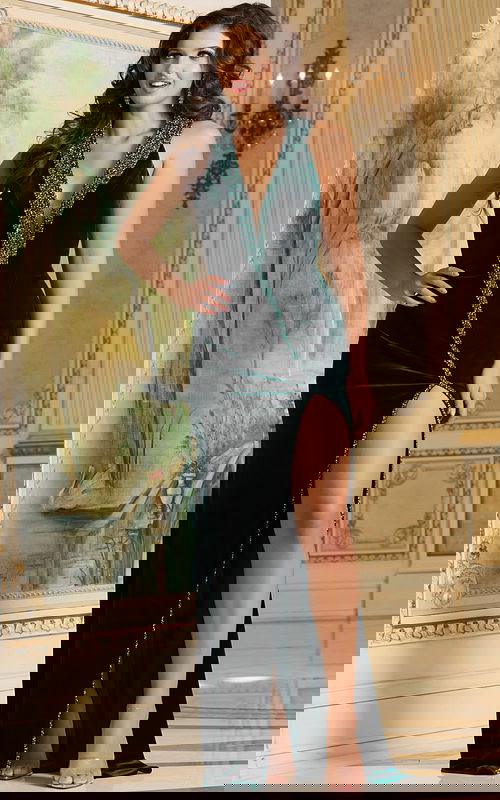 Model wearing Jovani 40119 green gown with V-neckline and high slit, front view.