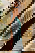 Model wearing Jovani 40119 green gown, back view showing sleek fit.